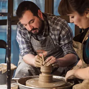 Two people at the potter's wheel